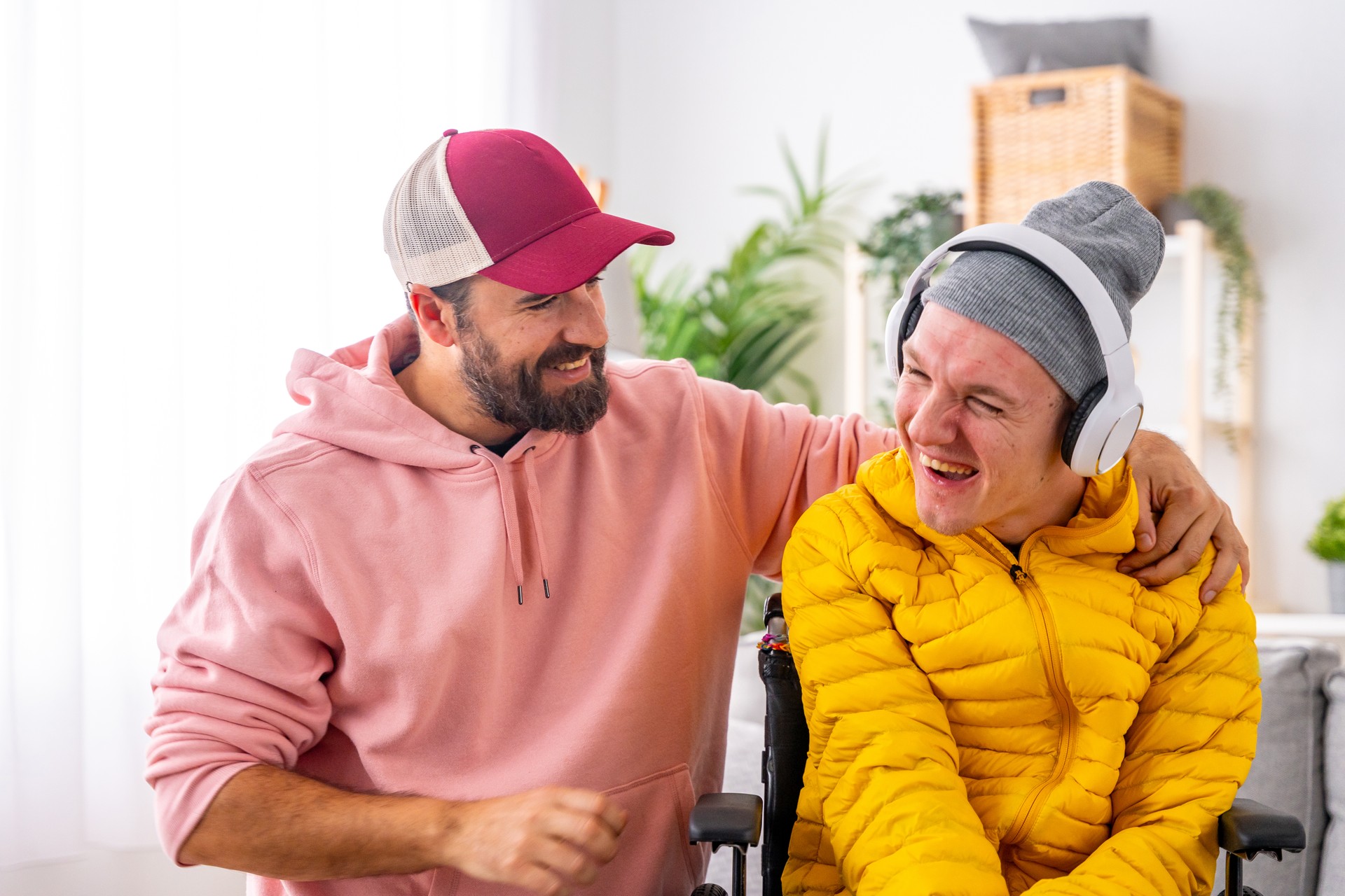 Disabled man and caregiver during art therapy session with music