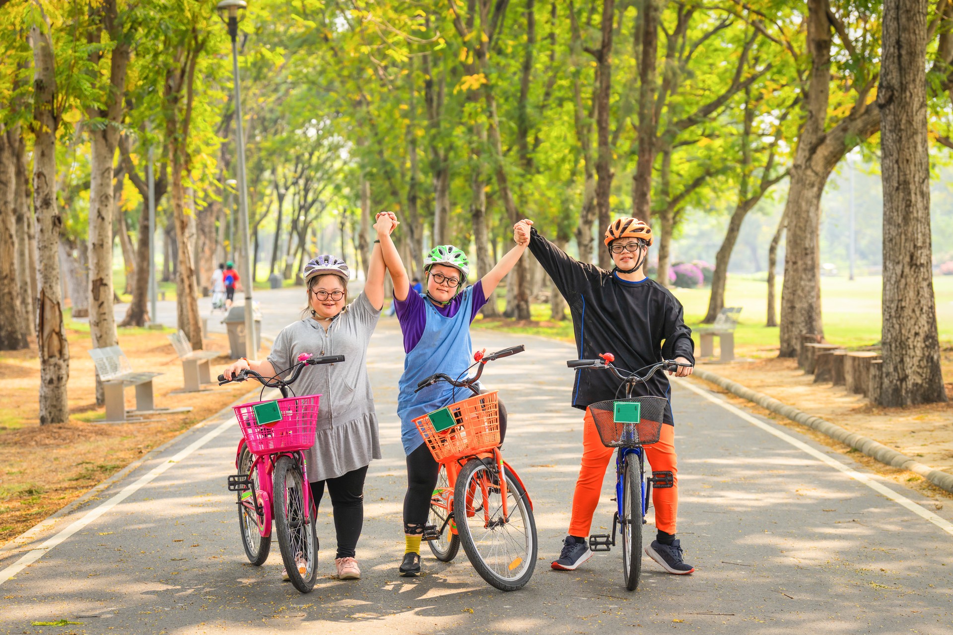 group of friends with down syndrome or autism riding bicycle together